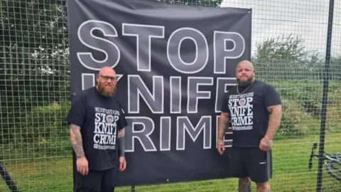 Be Lucky Anti Crime Foundation Jamie Hart and Paul Stansby wearing stop knife crime t-shirts