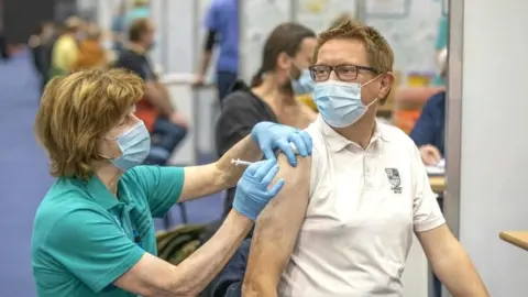 Getty Images Man receiving vaccination at centre in Belfast