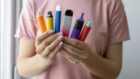 Getty Images Disposable vapes in a woman's hand