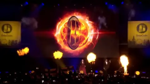 OneCoin Dr Ruja comes on stage at Wembley to the song This Girl Is On Fire