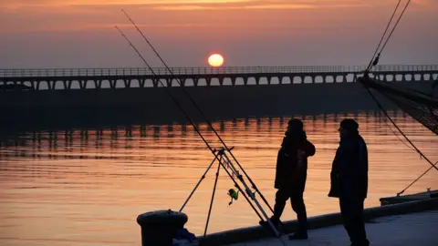 PA/Owen Humphreys Early-morning anglers in Blyth