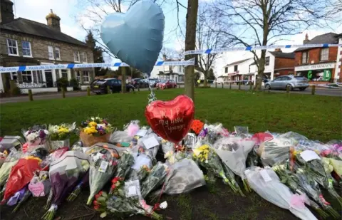 PA Media Floral tributes outside the pub