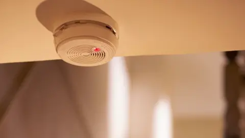 Getty Images Smoke alarm on the ceiling