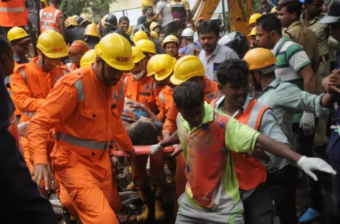 Ashish Vaishnav / Indus Images Rescuers at the scene in Mumbai