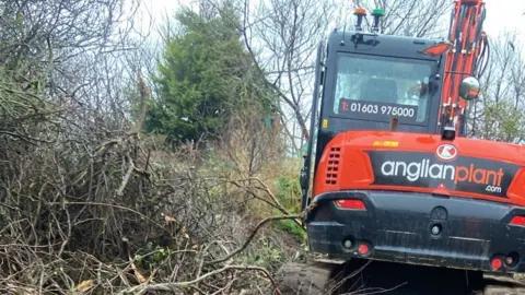 Dan Hurd/Hemsby Lifeboat Digger cutting through scrubland to create access road.