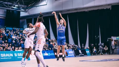 Mike Tuck Mike Tuck in blue playing basketball