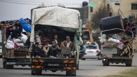 EPA-EFE/REX/Shutterstock Residents piled into the back of trucks evacuating Rafah, Gaza Strip