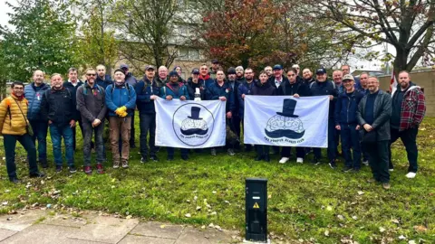 Scott Johnson A group of men holding two banners with the Proper Blokes Club logo.