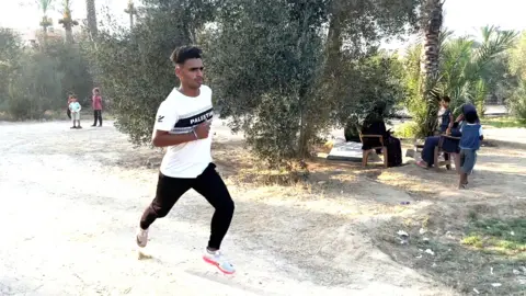 Tamer running in his Palestine tshirt 