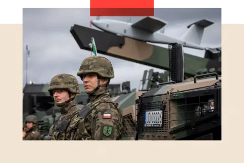 AFP via Getty Images Polish soldiers during a military equipment display 
