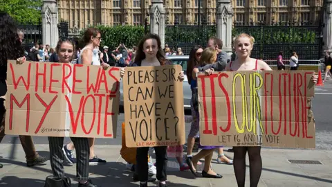 In Pictures via Getty Images Three young female protesters outside Parliament in central London hold placards reading: "Where was my vote", "Please Sir can we have a voice" and "It's our future: Let 16 and 17 vote", following the Brexit referendum in June 2016.