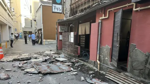 The exterior wall of a restaurant collapsed following the earthquake in Kumamoto City, southwestern Japan