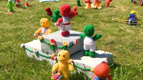 BBC Surrey Knitted figures on a podium 