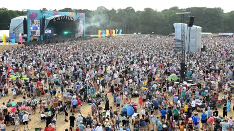 Getty Images Thousands of people together in a crowd in front of a stage at Latitude Festival.