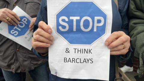 A poster saying 'stop and think Barclays'