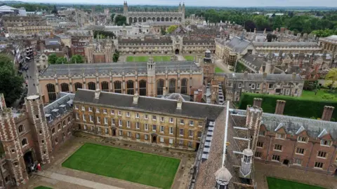 PA Media An aerial shot showing many Cambridge University colleges. In the foreground can be seen a quadrangle with grass in its middle, while behind are more college buildings and King's College Chapel is at the top of the photo