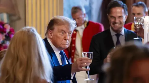 EPA Donald Trump raises his glass at a dinner with heads of state and government in The Hague