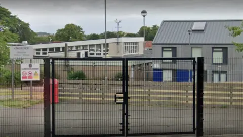 Google a google image of the front of Gilmerton Primary behind black gates