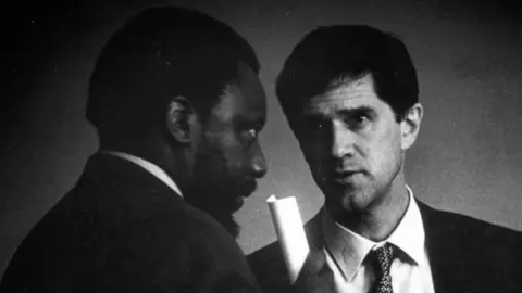 Gallo via Getty Images President Cyril Ramaphosa is seen with Roelf Meyer in this black and white image in the 1990s