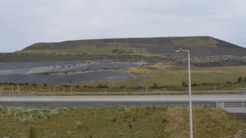 Chris Austin OB1, an overburden mound at Ffos-y-Fran opencast mine.  In the photo you can see the main A road running alongside the mine.