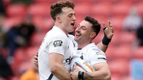 Bath's Bernard van der Linde hugs team-mate Louie Hennessey in celebration