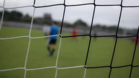 A stock photo of a black and white football net.