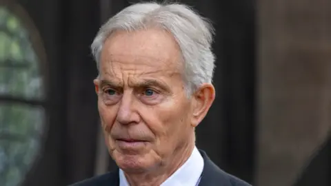 Tony Blair, pictured wearing a dark suit 