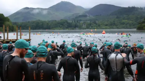 Route North  Lots of people getting into water wearing wetsuits.