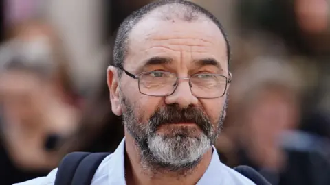 PA Media Andrew Malkinson arrives at the Royal Courts of Justice in London, ahead of his hearing at the Court of Appeal over his 2003 rape conviction. 