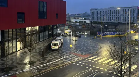An aerial image showing an empty street with police tap and vehicles.