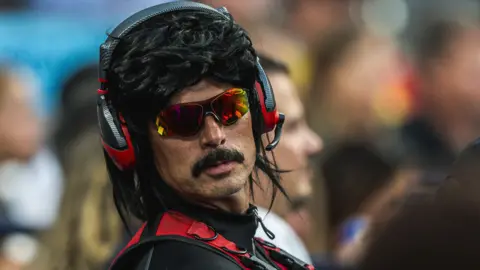 Getty Images Guy Beahm wearing sunglasses and a black mullet 