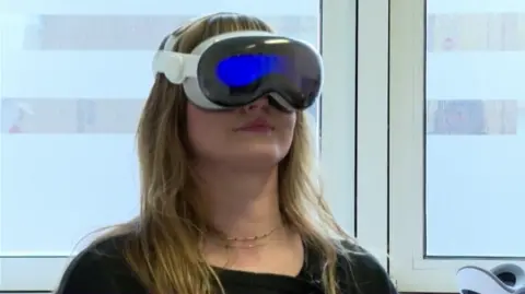 a woman with long blonde hair wears an AR headset