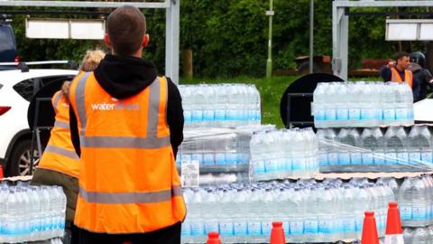 Broadsands Car Park, Brixham, Devon, UK, on 15 May 2024, where South West Water are handing out emergency rations of bottled water to anyone affected by the Cryptosporidium outbreak in Torbay