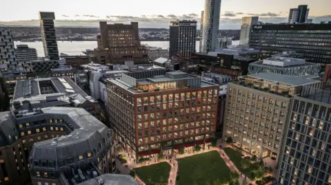 Liverpool City Council A computer generated image of a large development in Liverpool city centre called Pall Mall Gardens. It has an area of green space in the foreground and you can see the river Mersey in the background with skyscrapers against the early evening sky. 