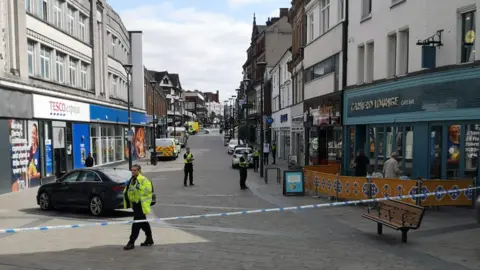 BBC A road cordoned off by police