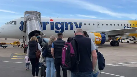 BBC Queues outside Aurigny's Embraer jet