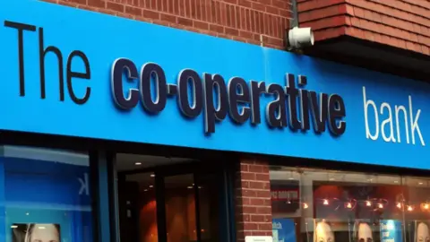 PA Media Frontage of Co-operative bank branch, with a blue sign prominent above the door