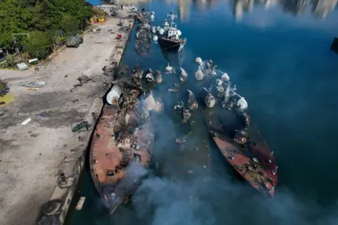 Getty Images An aerial photo shows Syrian naval ships destroyed during an overnight Israeli attack on the port city of Latakia on December 10, 2024