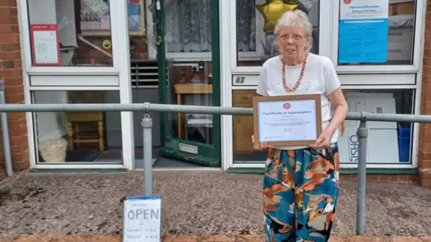 Jane Tudor outside her tiny Post Office