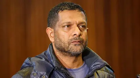 South Africa's deputy head of crime intelligence Feroz Khan is seen in court. He has short hair and a short beard