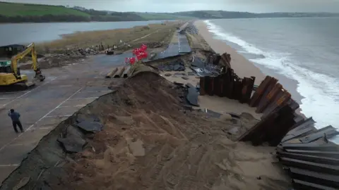 An aerial view of the A379 Slapton Line. It shows damage to the road and the Tank Car Park.