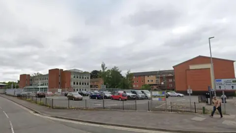 Google Southfields Extension car park with a number of red brick buildings in the background