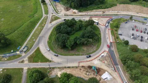 An aerial photograph of a roundabout, where construction works are taking place.