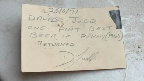 Ellie Mead A message on a card is signed "D Judd" and reads "26/6/71. David Judd. One pint best beer if penny (1945) returned."