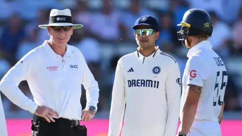 Umpire Paul Reifell (left), India captain Shubman Gill (centre) and England captain Ben Stokes (right)