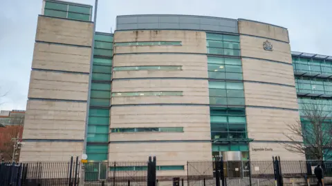PA Media Picture of the outside of Belfast crown court building.