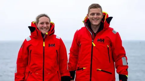 Kirstie Clubb Mhairi and Allan wearing red protective clothing