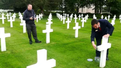 Andy Glenfield Andy Glenfield watching on as sand from Omaha Beach is put on the grave of Tony Vickery