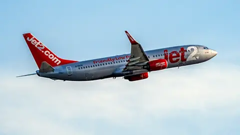 A picture of a Jet 2 plane. It is silver and red in colour. 
