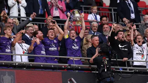Stoneham lift the FA Vase at Wembley